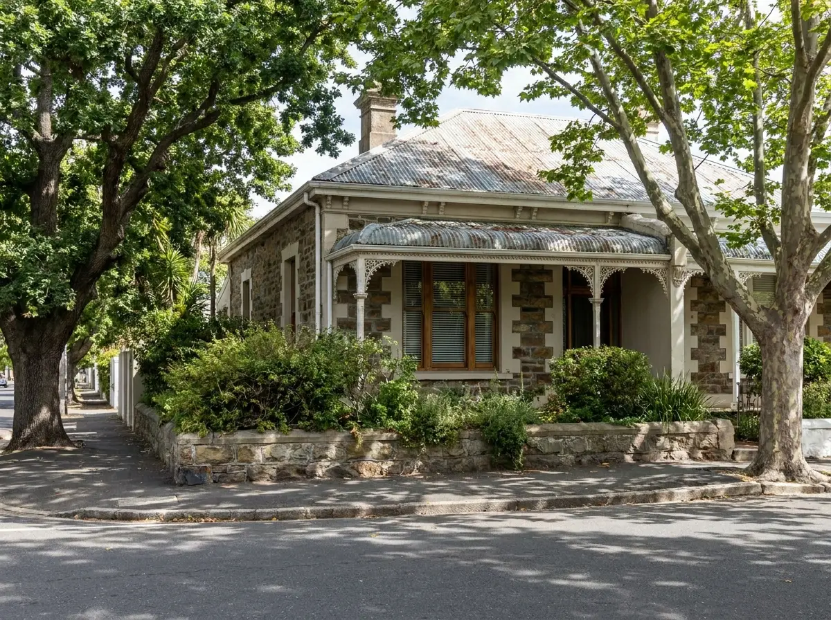 Established Victorian semi-detached cottage with cast-iron verandah trim on a leafy Kenilworth street, Cape Town